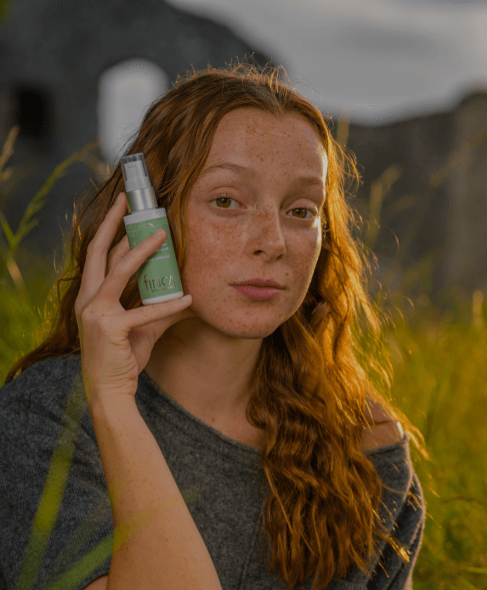 Girl holding finca skin organics product